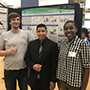 Jordan Rose, Logan Brown and Moises Rodriguez standing in front of their research poster.